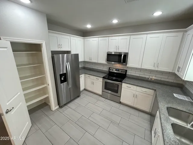 a kitchen with a refrigerator and a sink