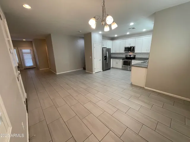 a view of a kitchen with a sink and cabinets