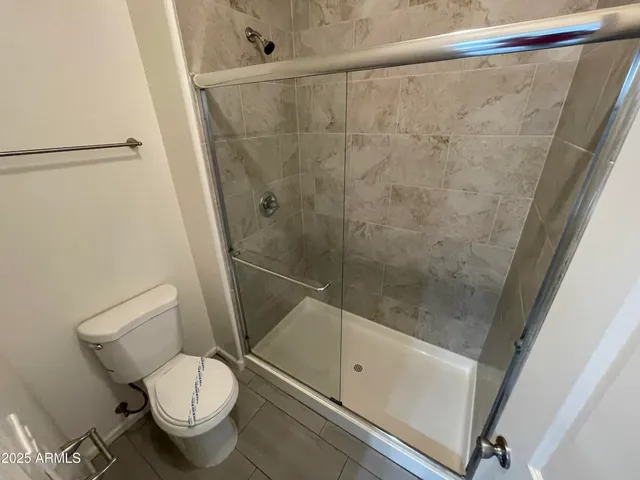 a bathroom with a toilet and a shower