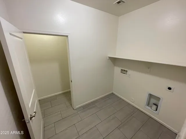 a view of storage and utility room with a hallway