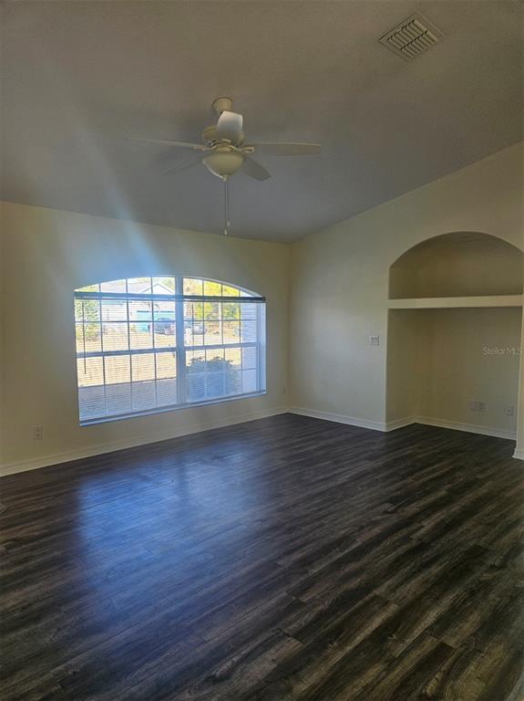 4138 Azora Street North Port, FL 34291 - Photo 11 of 37 an empty room with wooden floor and windows