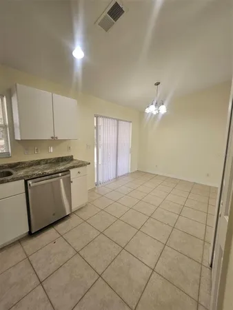 a kitchen with a sink cabinets and appliances