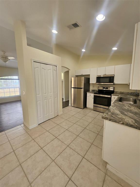 4138 Azora Street North Port, FL 34291 - Photo 18 of 37 a kitchen with stainless steel appliances granite countertop a refrigerator and a stove