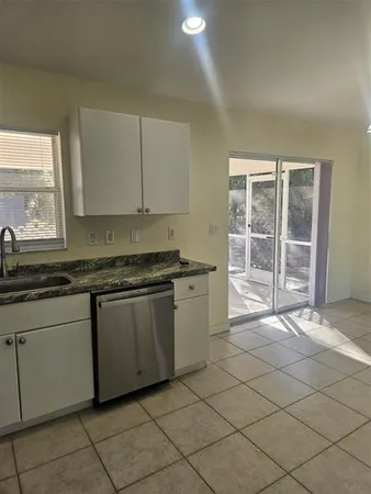 a kitchen with stainless steel appliances granite countertop a sink and a cabinets