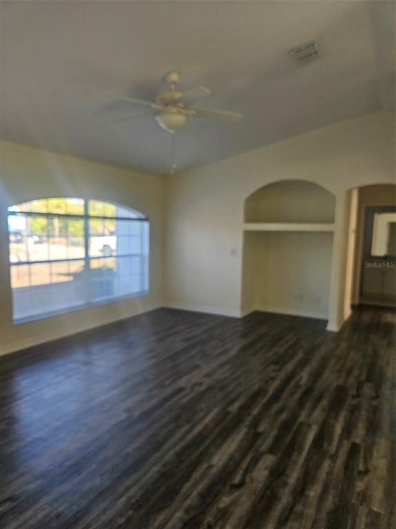 4138 Azora Street North Port, FL 34291 - Photo 9 of 37 an empty room with wooden floor and windows