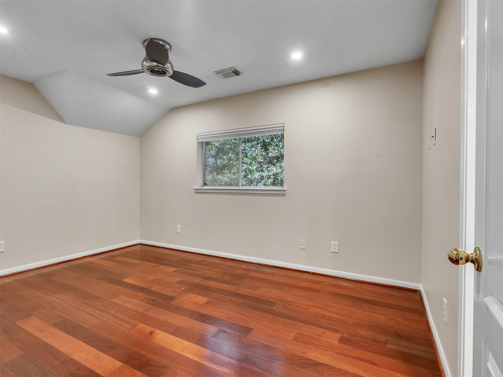 4414 Santee Drive Baytown, TX 77521 - Photo 38 of 50 an empty room with wooden floor chandelier fan and windows