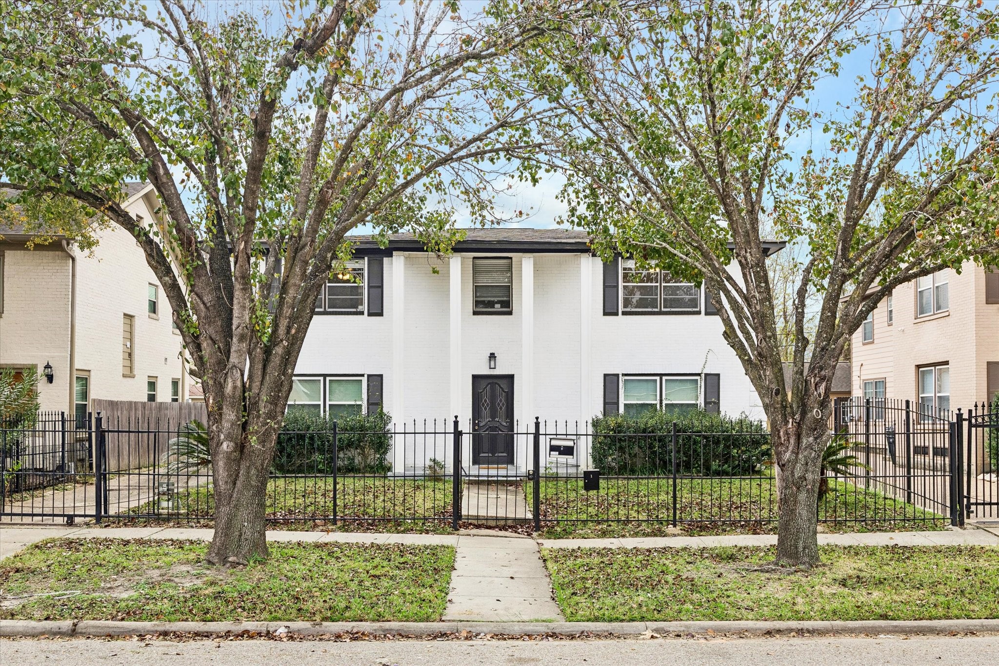 A timeless Houston classic. The handsome brick exterior and structured fencing establish an immediate sense of privacy and permanent value in a premier urban pocket.