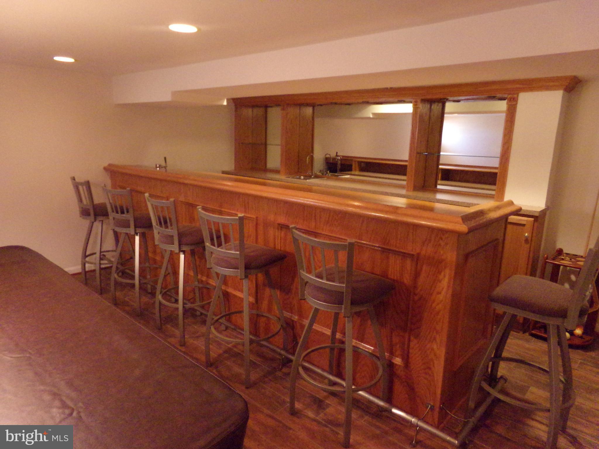 11200 Snowden Pond Road Laurel, MD 20708 - Photo 59 of 63 full bar with bar stools that convey