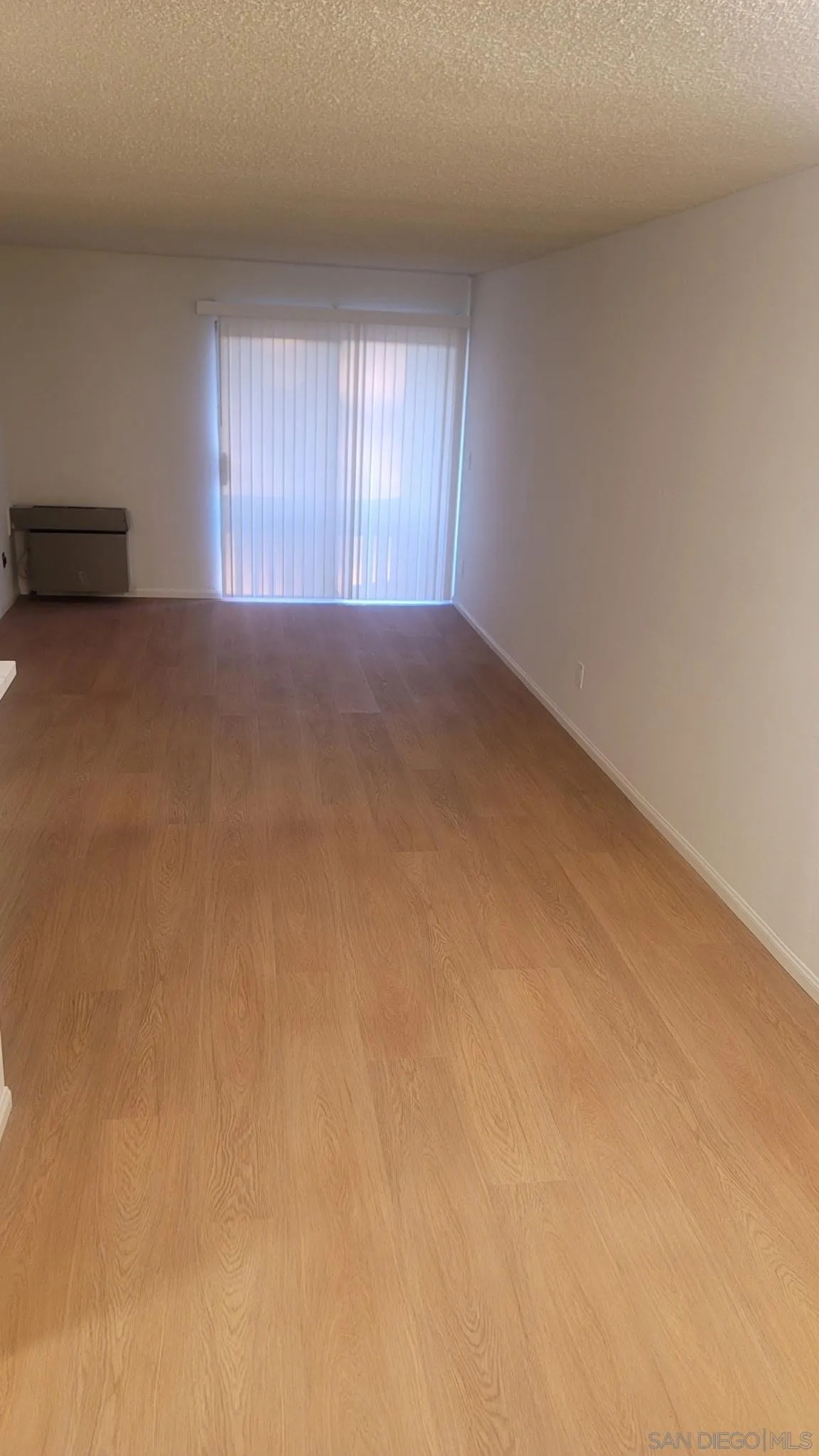 6255 Rancho Mission Road, Unit 102 San Diego, CA 92108 - Photo 2 of 7 a view of an empty room with a window
