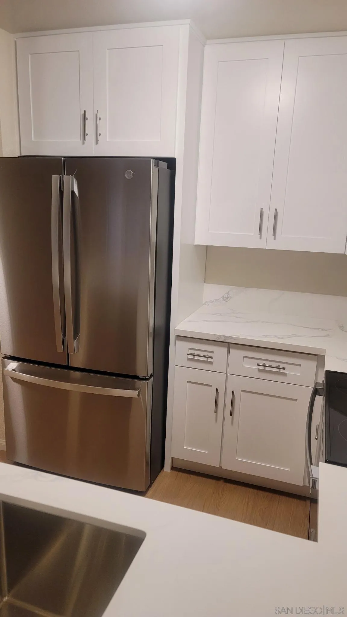 6255 Rancho Mission Road, Unit 102 San Diego, CA 92108 - Photo 5 of 7 a kitchen with appliances and cabinets