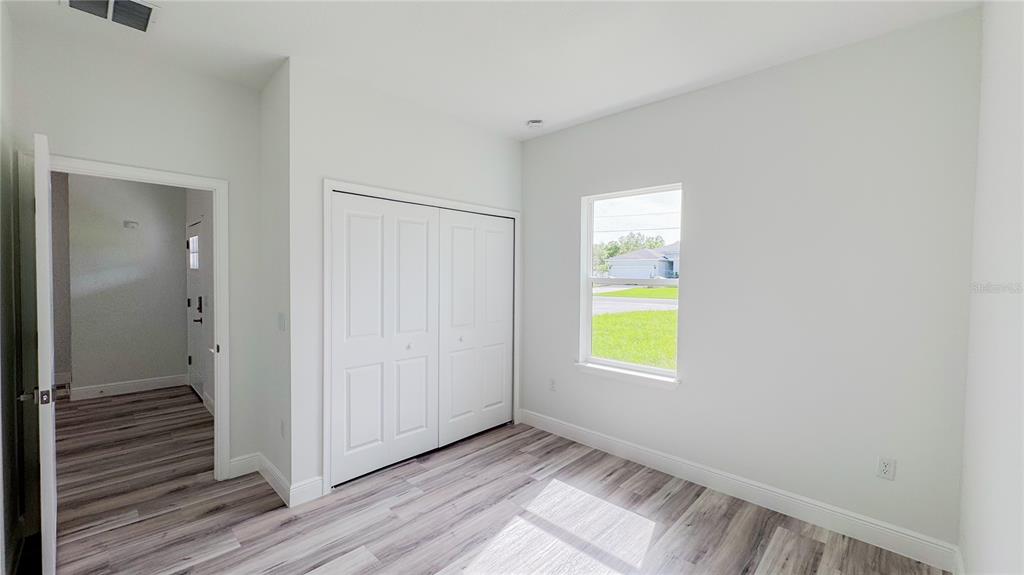 15625 Southwest 37th Circle Ocala, FL 34473 - Photo 14 of 27 a view of an empty room with wooden floor and a window