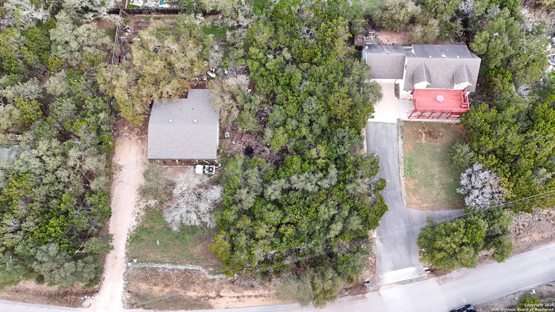 1237 Springwater Canyon Lake, TX 78133 - Photo 1 of 5 an aerial view of a house with outdoor space and trees all around