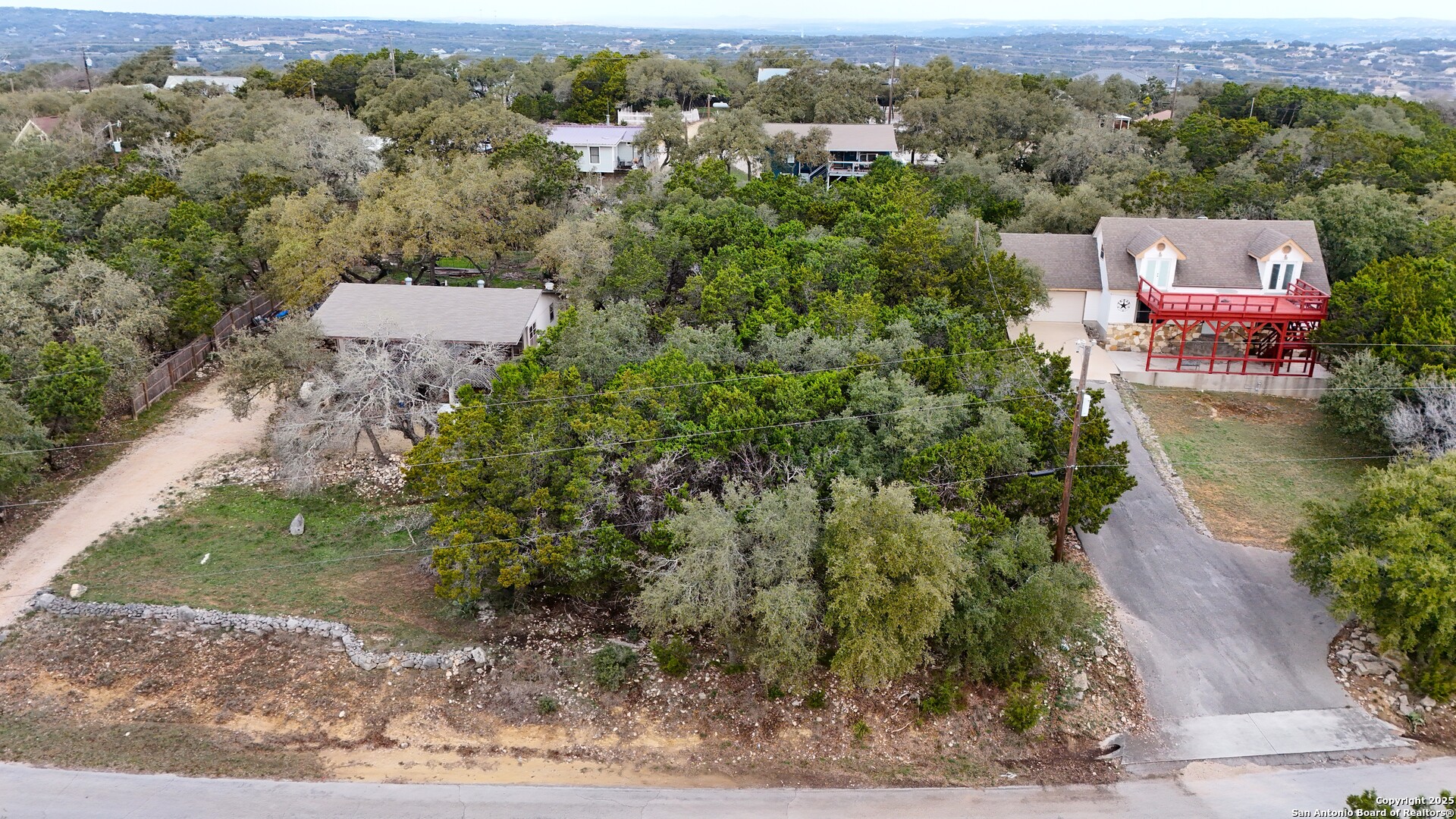 1237 Springwater Canyon Lake, TX 78133 - Photo 2 of 5 an aerial view of a house with a yard