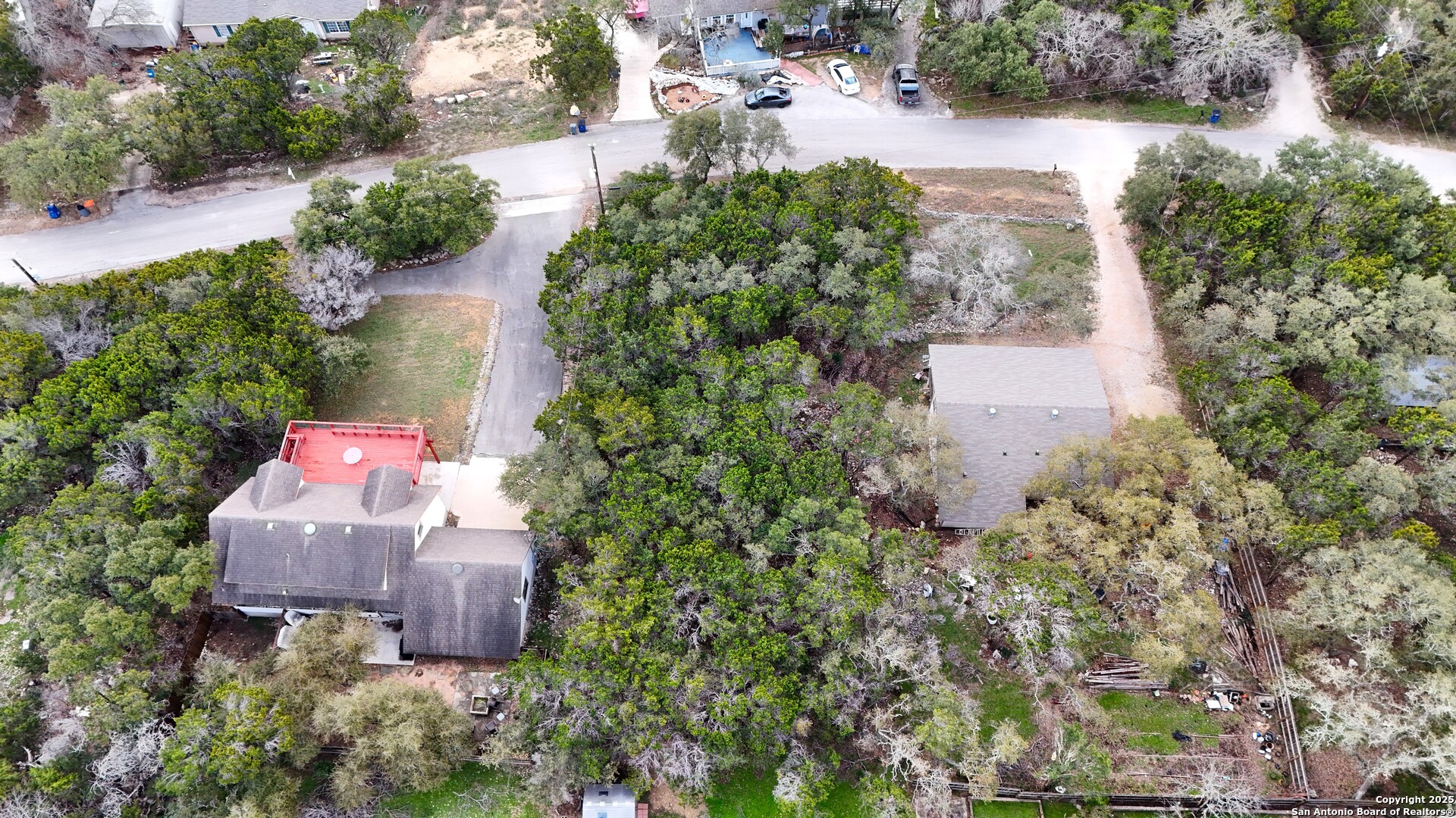 1237 Springwater Canyon Lake, TX 78133 - Photo 5 of 5 an aerial view of a house with a yard and lake view