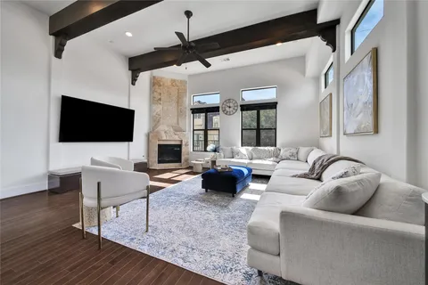 a living room with fireplace furniture and a flat screen tv