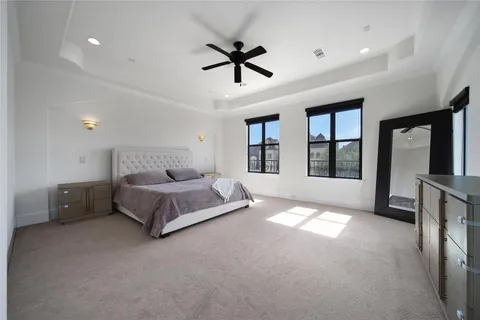 a spacious bedroom with a bed and a large window