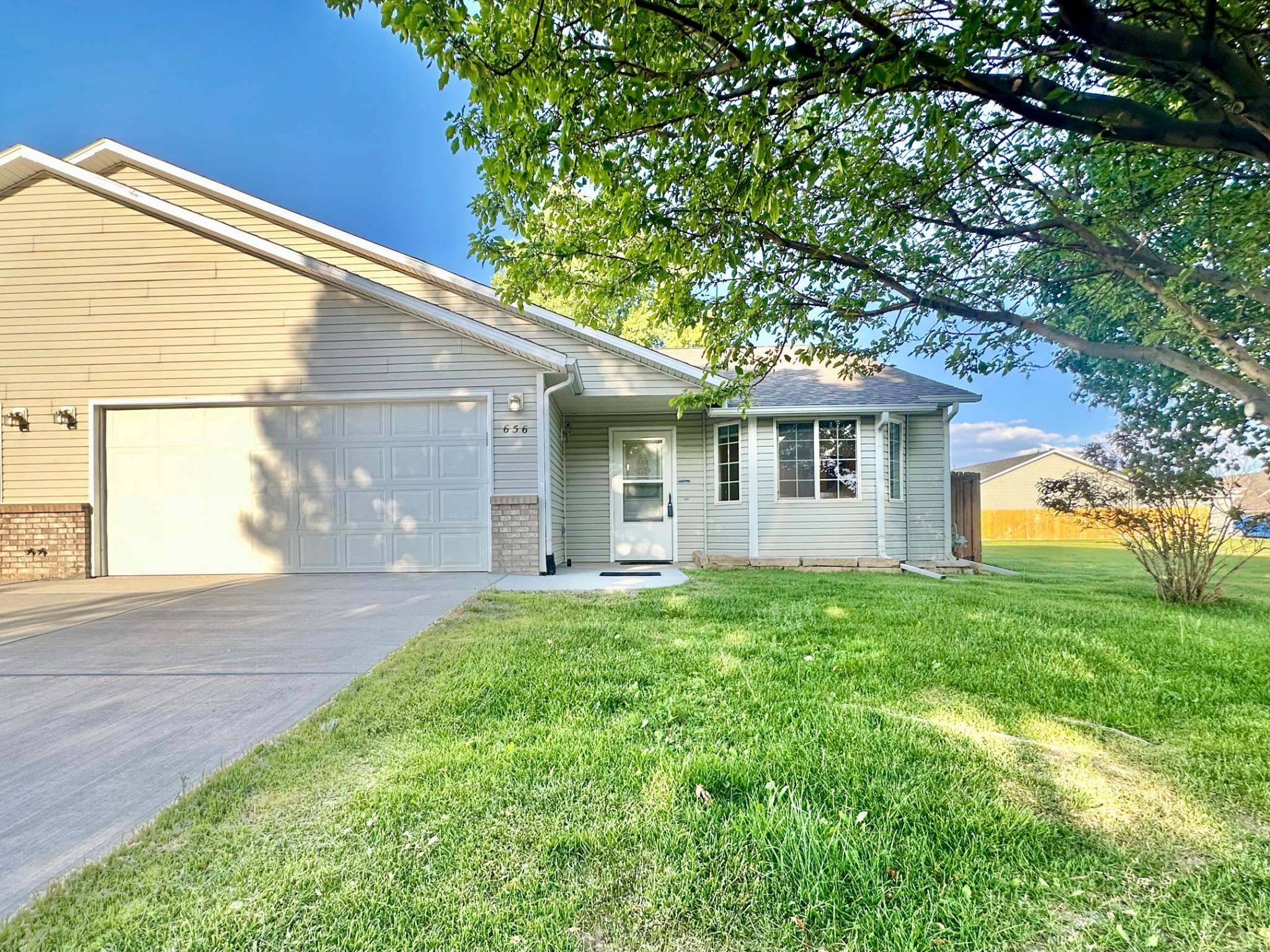 656 Springbrook Drive Grand Junction, CO 81504 - Photo 1 of 32 a view of a yard in front of a house with plants and large tree