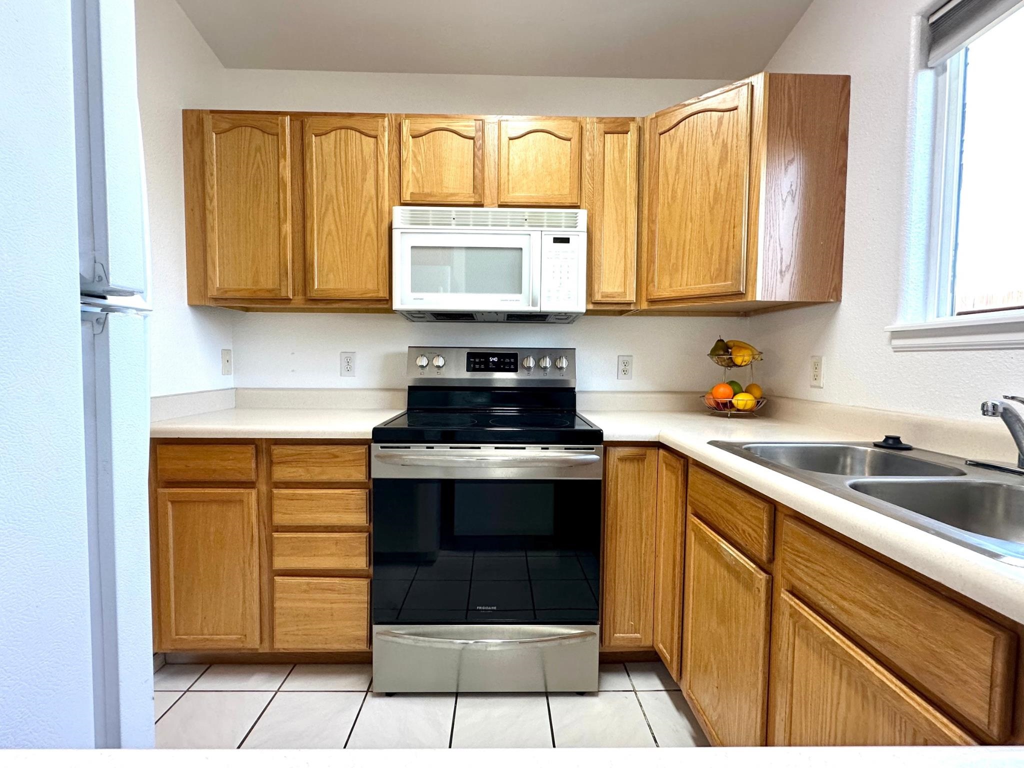 656 Springbrook Drive Grand Junction, CO 81504 - Photo 13 of 32 a kitchen with stainless steel appliances granite countertop a stove a sink and a refrigerator