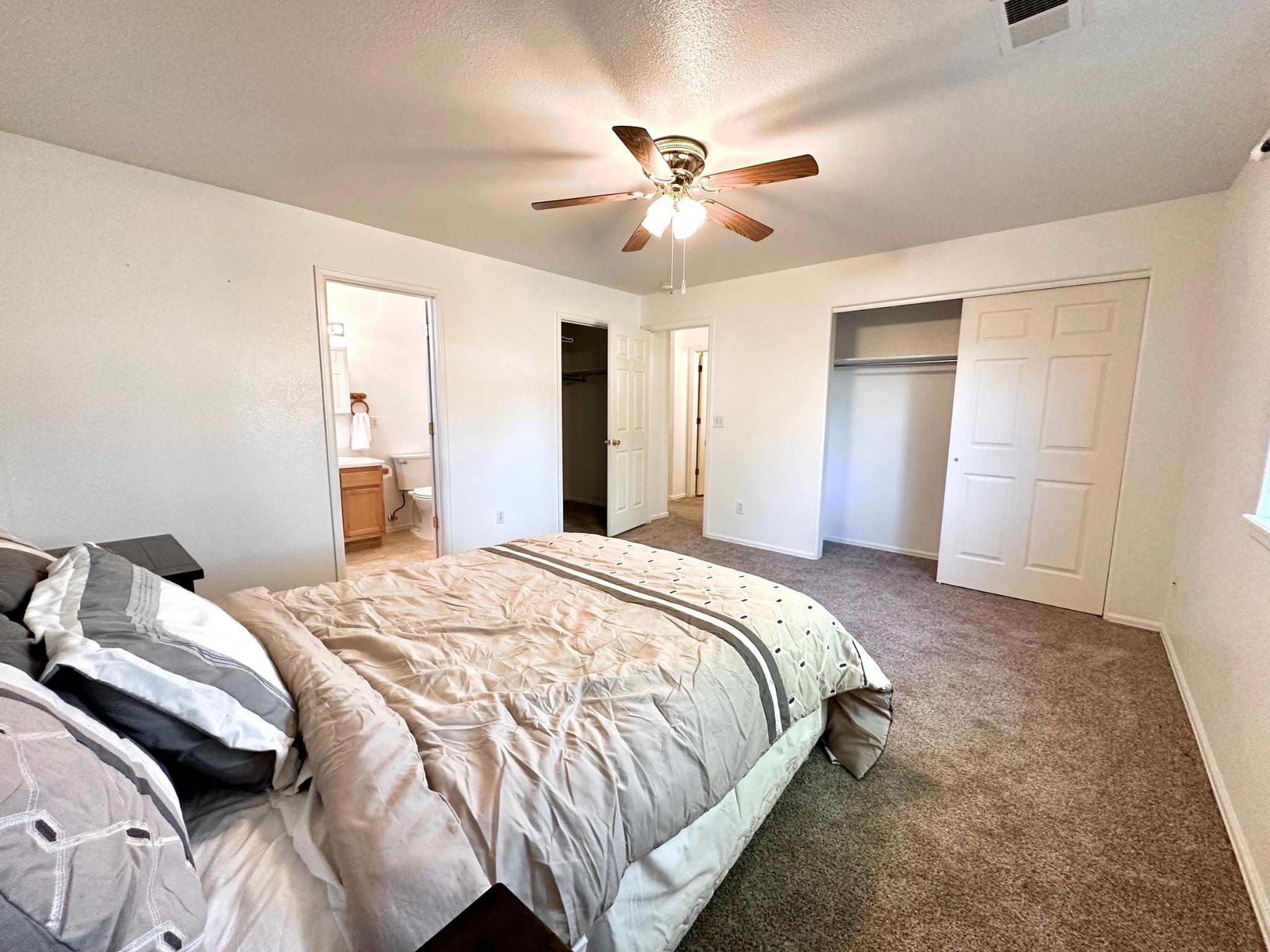 656 Springbrook Drive Grand Junction, CO 81504 - Photo 16 of 32 a bedroom with a bed and a chandelier