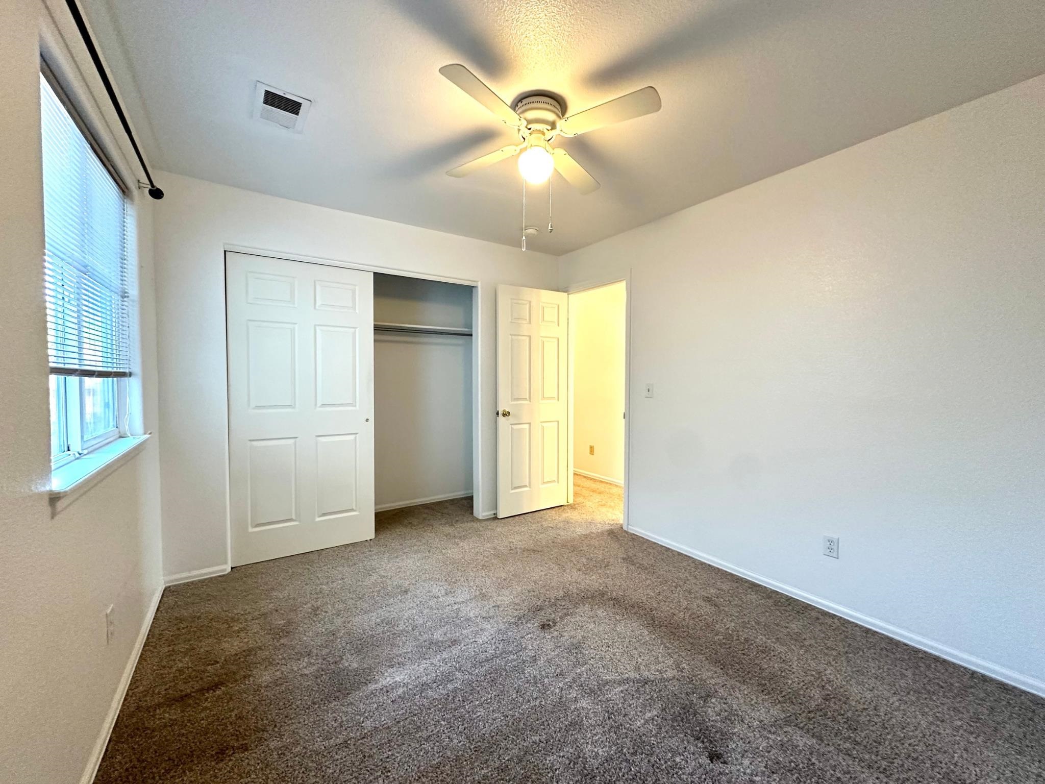 656 Springbrook Drive Grand Junction, CO 81504 - Photo 19 of 32 an empty room with closet and a ceiling fan