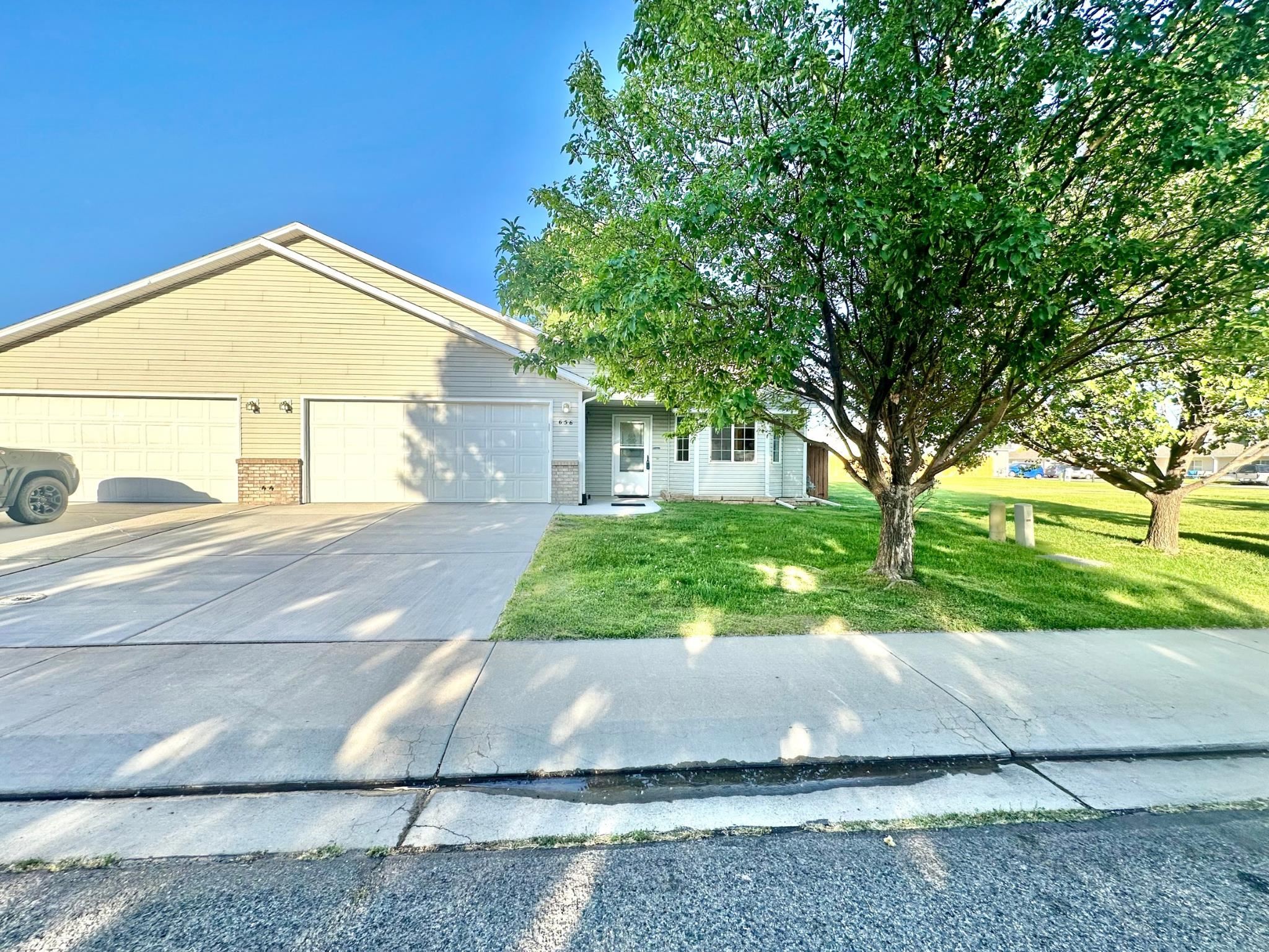 656 Springbrook Drive Grand Junction, CO 81504 - Photo 2 of 32 a view of a house with a yard and large tree