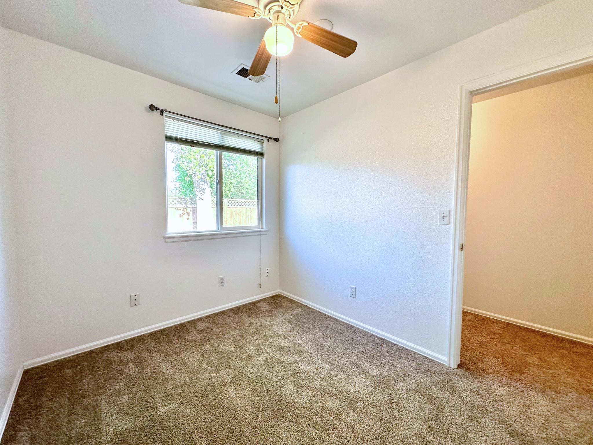 656 Springbrook Drive Grand Junction, CO 81504 - Photo 22 of 32 an empty room with a window and a fan