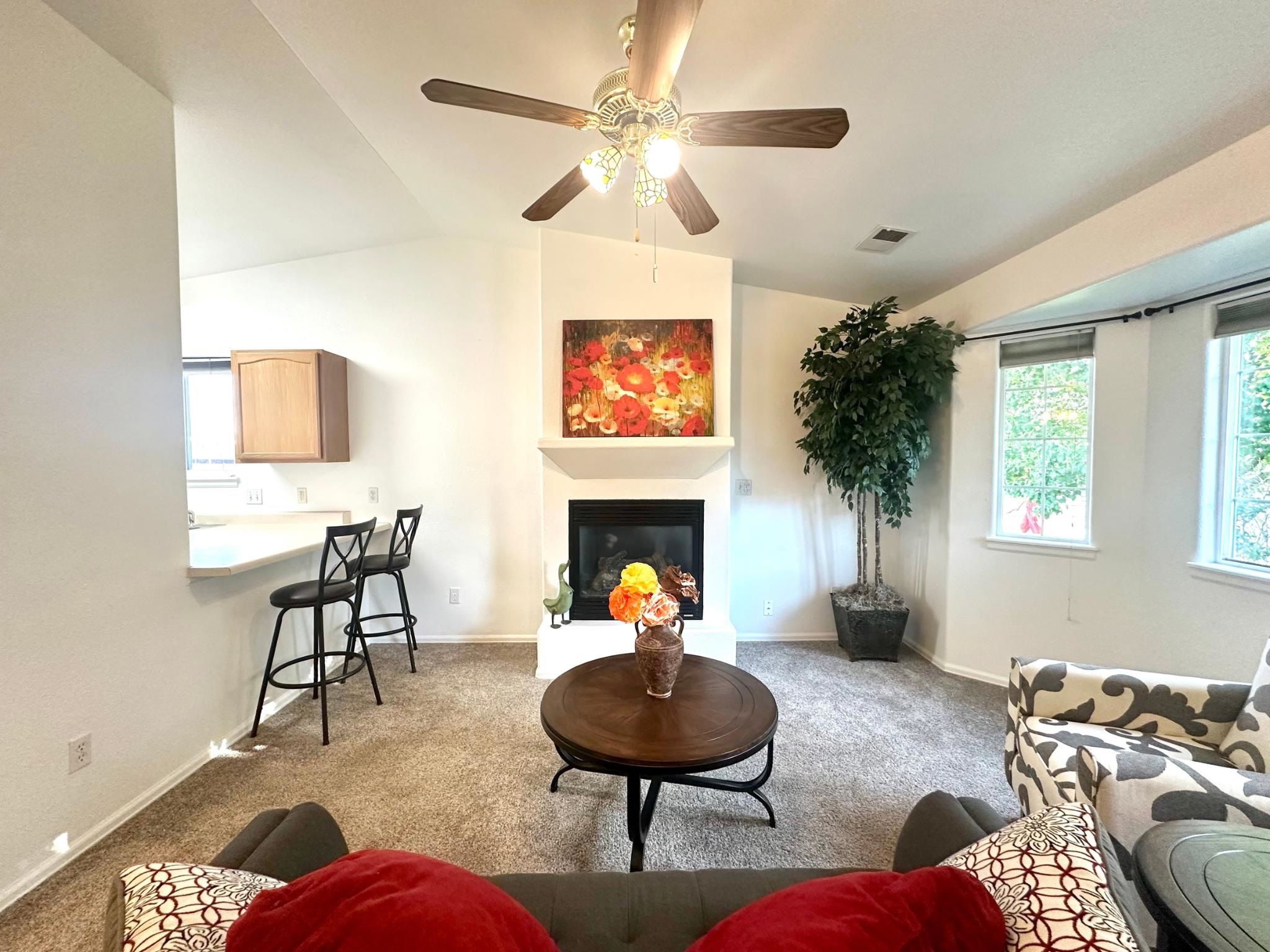 656 Springbrook Drive Grand Junction, CO 81504 - Photo 5 of 32 a living room with furniture a fireplace and a chandelier