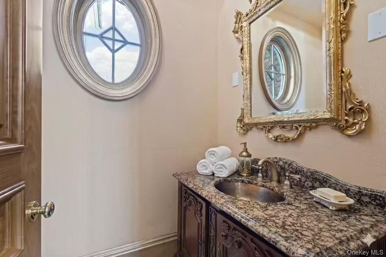 660 Chicken Valley Road Locust Valley, NY 11560 - Photo 16 of 48 a bathroom with a granite countertop sink and a mirror