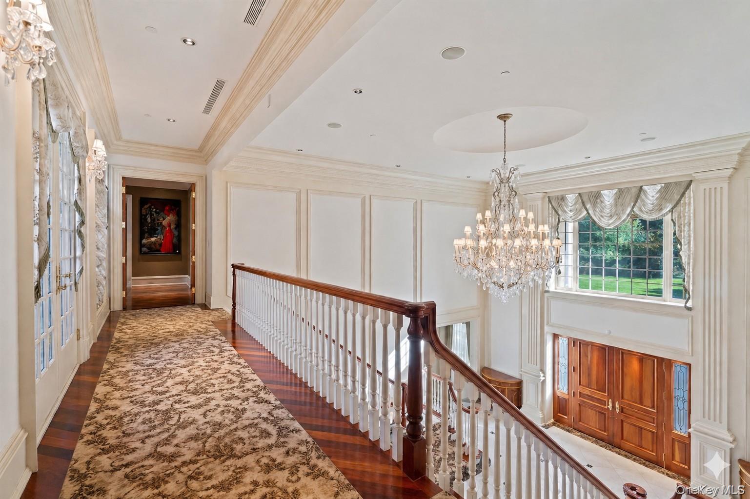 660 Chicken Valley Road Locust Valley, NY 11560 - Photo 18 of 48 Grand foyer with a double-height ceiling, showcasing a large crystal chandelier and an arched window
