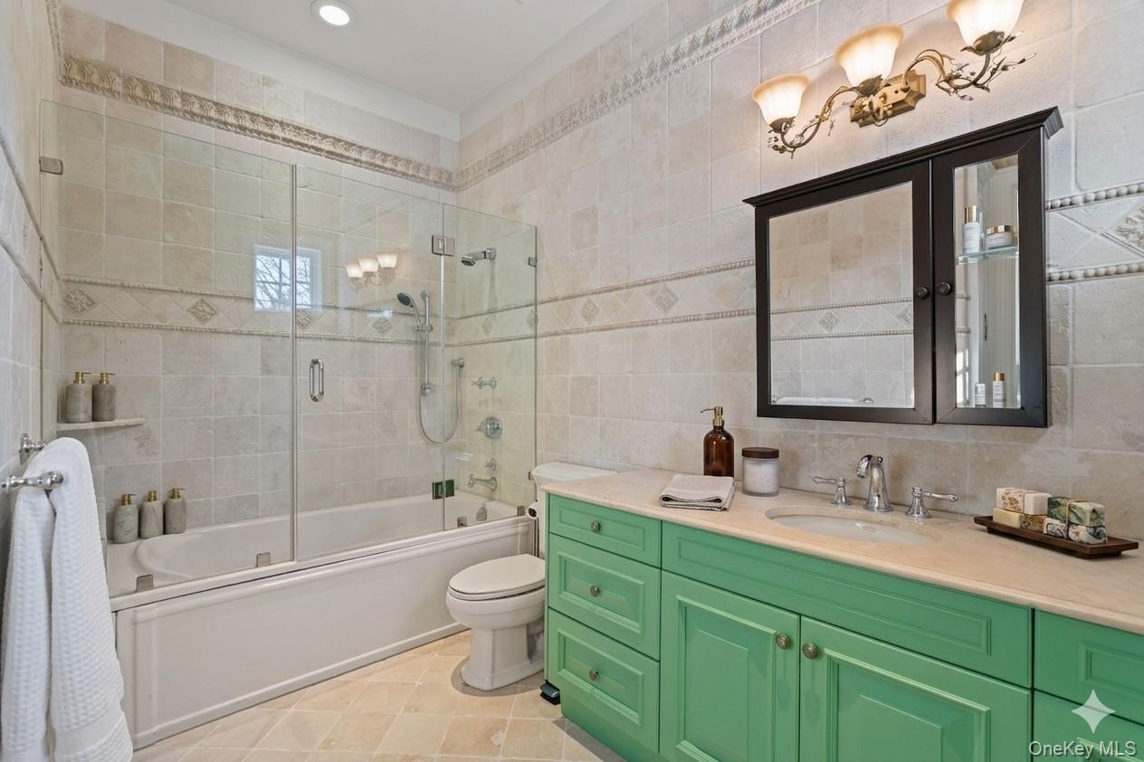 660 Chicken Valley Road Locust Valley, NY 11560 - Photo 31 of 48 a bathroom with a granite countertop sink toilet and shower