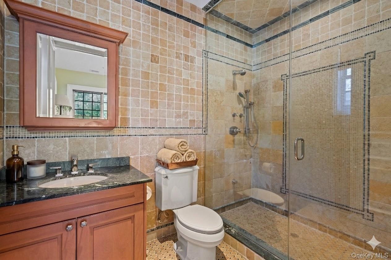 660 Chicken Valley Road Locust Valley, NY 11560 - Photo 33 of 48 a bathroom with a sink a toilet and shower