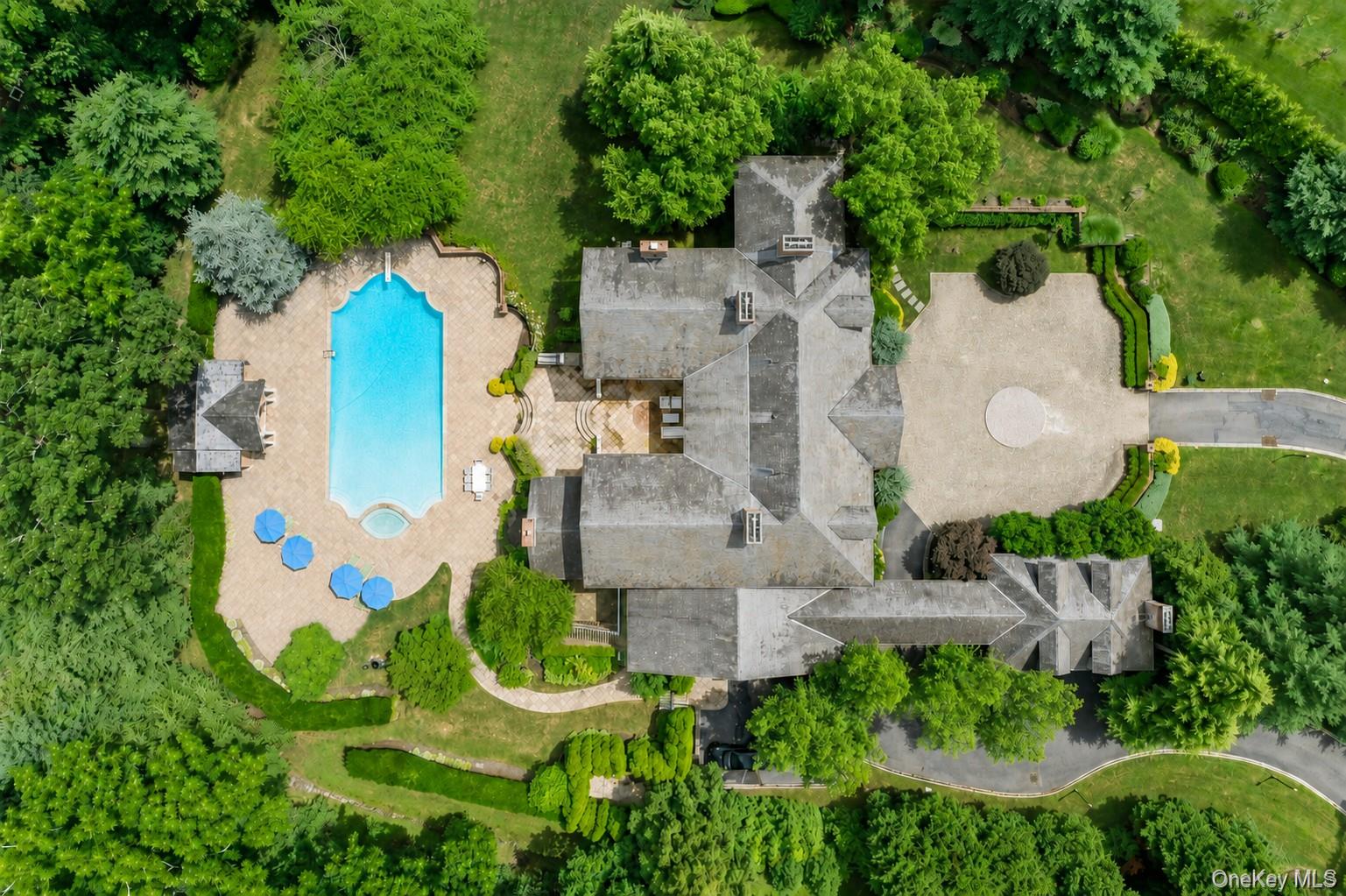 660 Chicken Valley Road Locust Valley, NY 11560 - Photo 42 of 48 an aerial view of a house with a swimming pool and tennis court