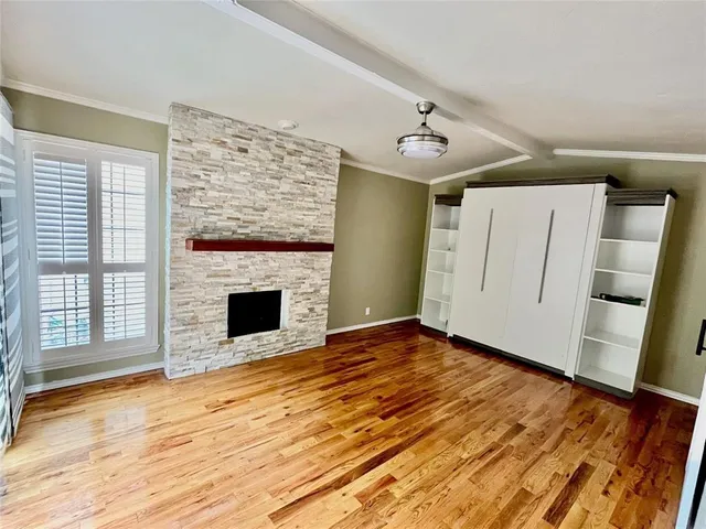 a view of a livingroom with a ceiling fan and wooden floor