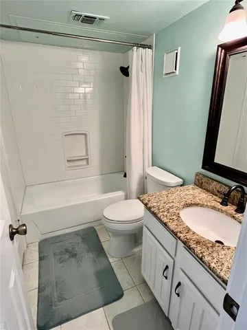 an empty room with a window and a ceiling fan