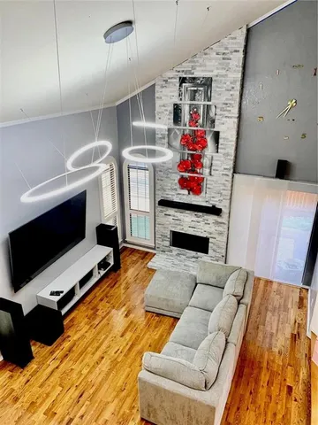 a view of a living room kitchen and a flat screen tv