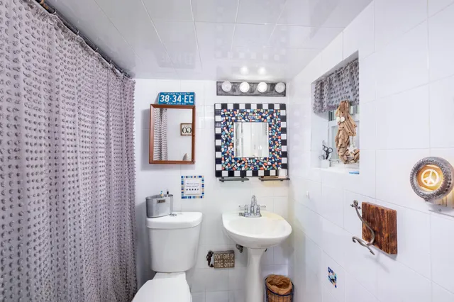 a bathroom with a sink mirror and toilet