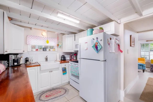 a white refrigerator freezer sitting inside of a kitchen