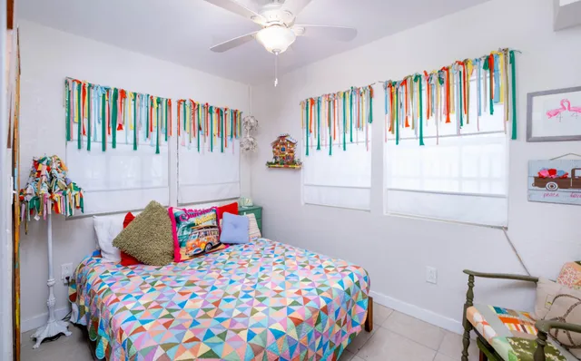 a bedroom with furniture and a large window
