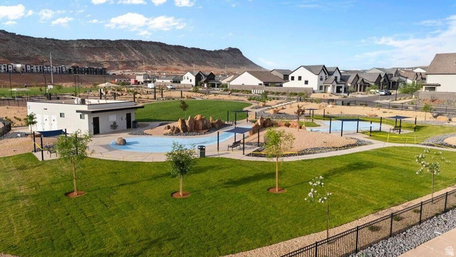 2123 Wolverine Way, Unit 2437 Washington, UT 84780 - Photo 10 of 40 Community park featuring a splash pad with multiple water features, expansive manicured lawns, and mature landscaping