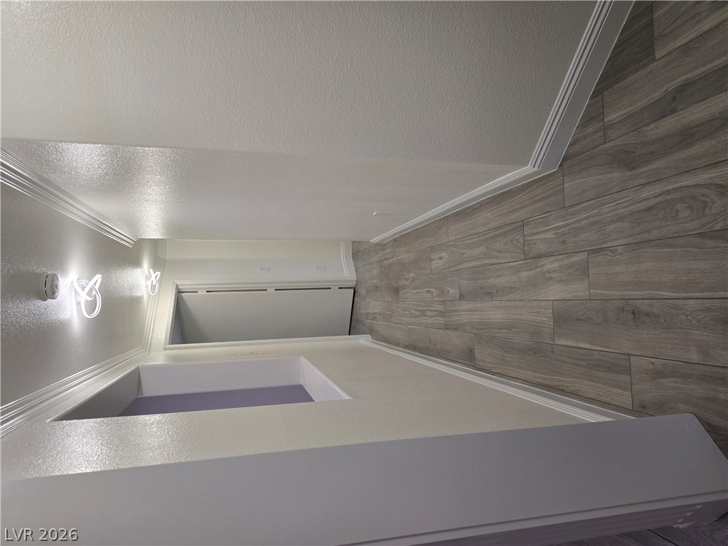 1881 West Alexander Road, Unit 1127 North Las Vegas, NV 89032 - Photo 16 of 20 Elegant crown molding adorns this stylish hallway, complemented by sophisticated wood-plank flooring.