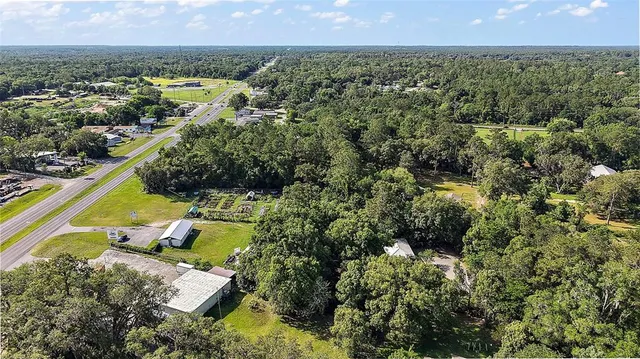 an aerial view of a yard with a swimming pool