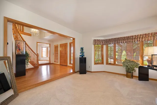 a big room with wooden floor and windows