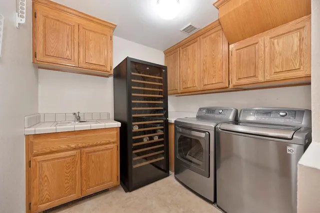 a kitchen with stainless steel appliances granite countertop a refrigerator sink and stove