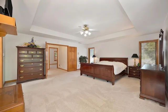 a bedroom with a bed and a chandelier