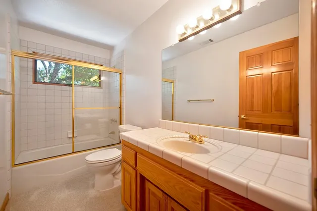 a bedroom with a large bed and wooden floor