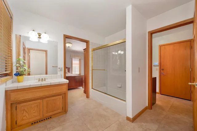 a bedroom with a large bed and a window