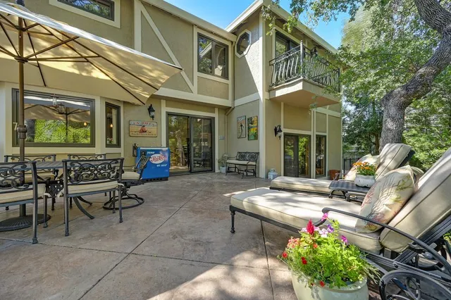 a view of a house with backyard fountain and sitting area