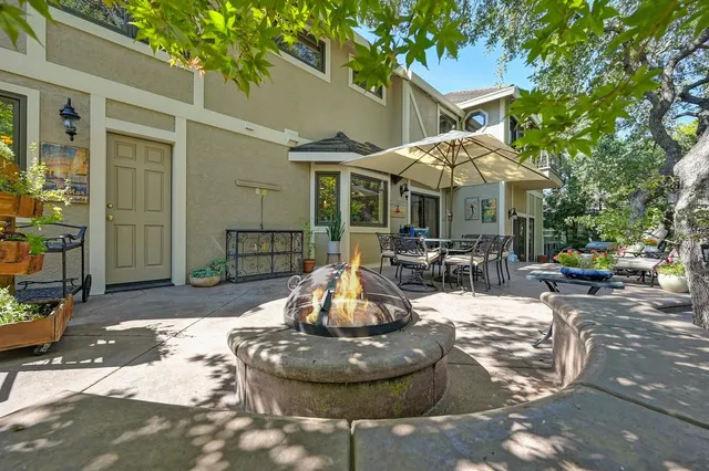 a view of a house with a yard and sitting area