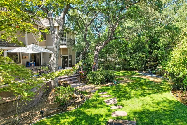 a view of a patio with table and chairs and potted plants