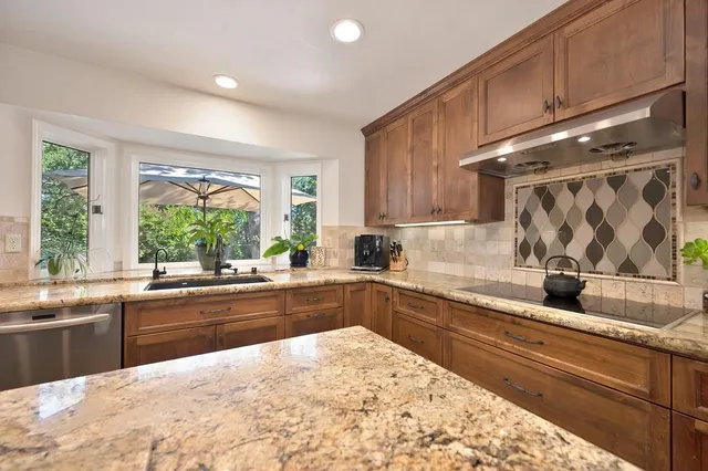a kitchen with a stove a sink and a refrigerator
